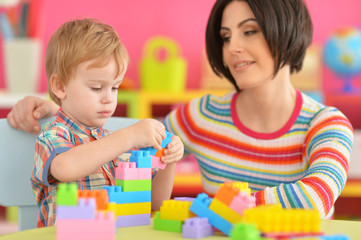 Fototapeta premium Young mother playing with son