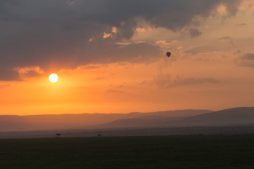 Fototapeta premium balloon against the clouds of a sunrise, Maasai Mara, Kenya