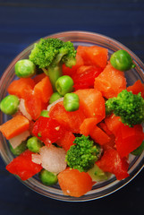 Close up of Vegetarian and Healthy Vegetables Mix Carrots, Pepper, Onion, Peas, Brocoli. Health and Beauty. Dark Blue Background. Vertical Image.
