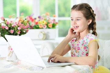 little girl using laptop