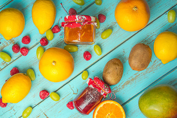 Fruits on a light blue rustic table. Grapefruit, grapes,blackberries and lemons. Healthy food