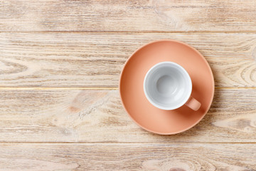 empty colourful cup on plate for coffee or tea on wood background