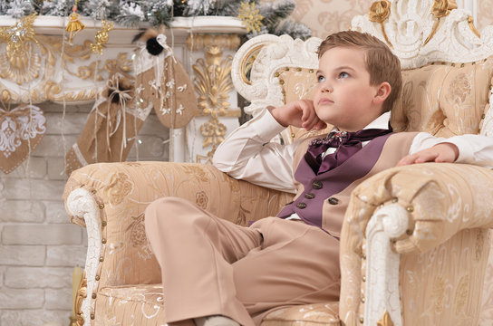 little boy  sitting on chair on  Christmas 
