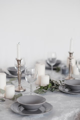 Fototapeta na wymiar Table setting in light colors with candles