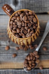 Roasted coffee beans in a clay mug 