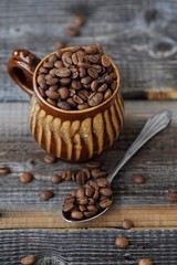 Roasted coffee beans in a clay mug 