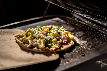 home made pizza with mushroom, basil and pineapple made on grill - 190391749