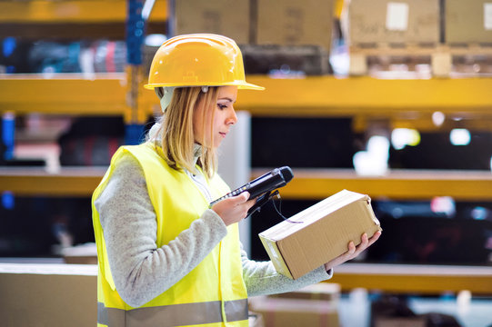 Warehouse woman worker with barcode scanner.