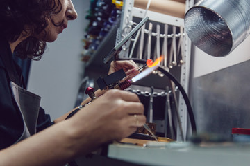 Glass blower makes the costume jewelery from the Venetian glass.