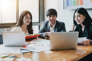 Group of Asian Business People with casual suit are working with a financial for marketing in the modern Office or coffee shop, Business marketing concept..