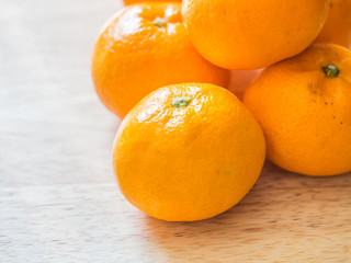 Closeup of oranges on wooden table.