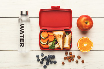 Lunch box with healthy food on white table background