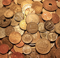 Background from coins. The currencies of different countries as a symbol of abundance of money. Backdrop of the scattering metal cash. Square location.