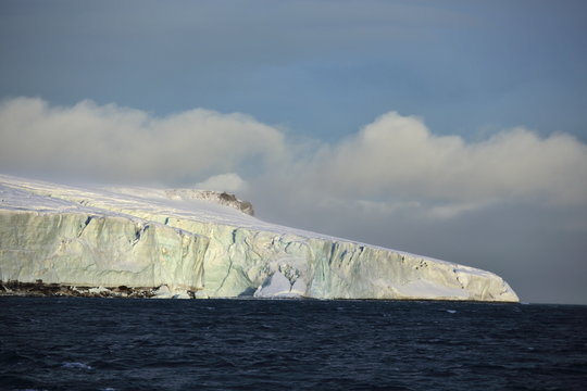Edge of the Arctic island covered with glacier
