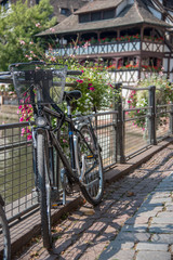 Fototapeta na wymiar Black bicycle attached to metal gate railing on a city street, France, Strasbourg