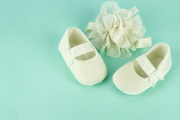 Waiting for baby. white ballet shoes for newborn on a pastel blue background. copy space
