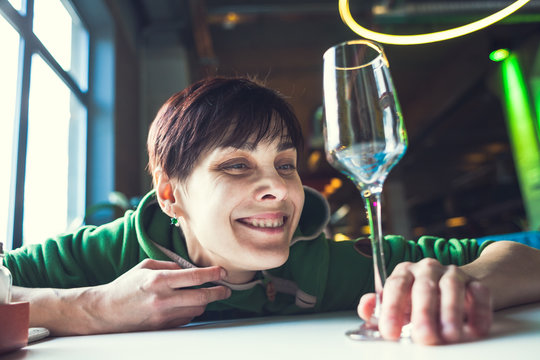 A drunk woman is sitting at a table.