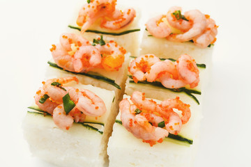Set of rolls with soft cheese and shrimps on top, isolated