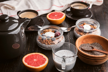 breakfast with chia, yoghurt and granola on a wooden table