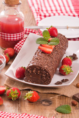 Chocolate roll with hazelnuts and strawberries. 