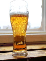 a glass of beer by the window