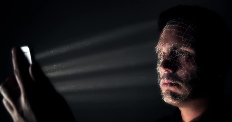 Inside the technical workings of facial recognition software. Camera floats inside the pixels mapping a face whilst using a cell phone - Powered by Adobe