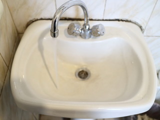 white sink with a tap for water