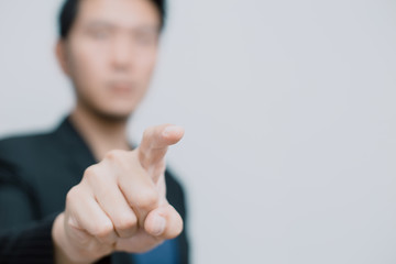 Asian business man pointing his finger to touch or order command on white space