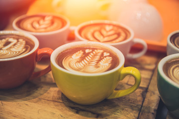 coffee latte art popular hot drink served on wood table in cafe.