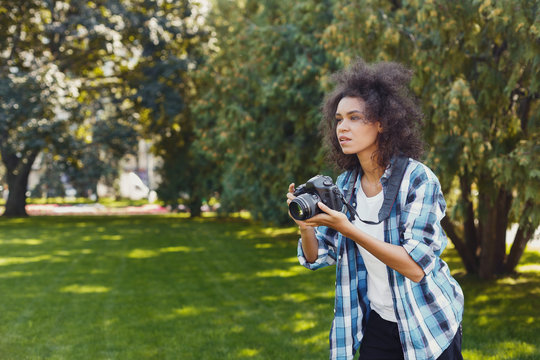Young woman taking pictures outdoors