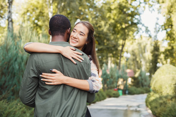 Fototapeta premium Happy couple hugging in park copy space