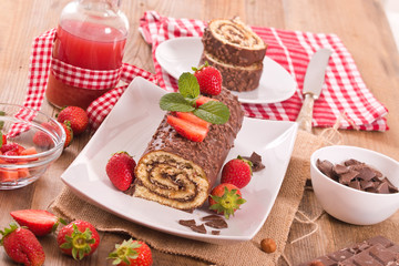 Chocolate roll with hazelnuts and strawberries. 