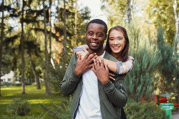 Fototapeta premium Happy couple hugging in park copy space