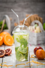 Mojito cocktail in a bur on rustic table