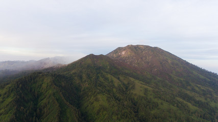 Beautiful sunset in the mountains on Jawa island, Indonesia. Aerial view of mountains landscape...