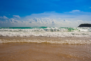 All you need is a great blue sky, white clouds, turquoise water, rhythmic waves and fine sand to have a great vacation at Kata Beach, Phuket, Thailand.