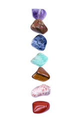 Set of seven healing chakra stones for crystal healing, isolated on white background 