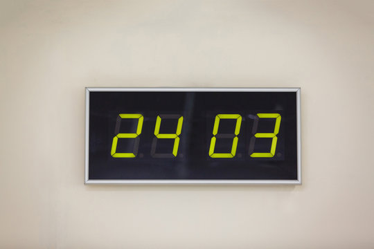 Black digital clock on a white background showing time 24 03 Hour Earth;
