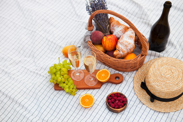 Two glasses of champagne. Picnic on the beach at sunset in the white plaid, food and drink conception