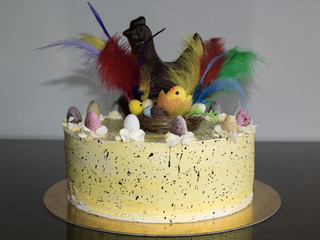 a mona de pascua, a cake eaten in Spain on Easter Monday, ornamented with feathers and a chocolate...