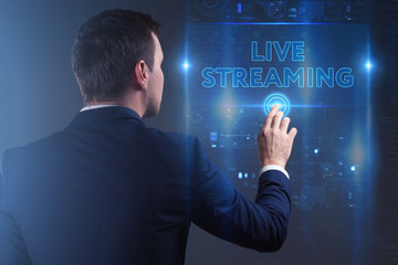 Business, Technology, Internet and network concept. Young businessman working on a virtual screen of the future and sees the inscription: Live streaming