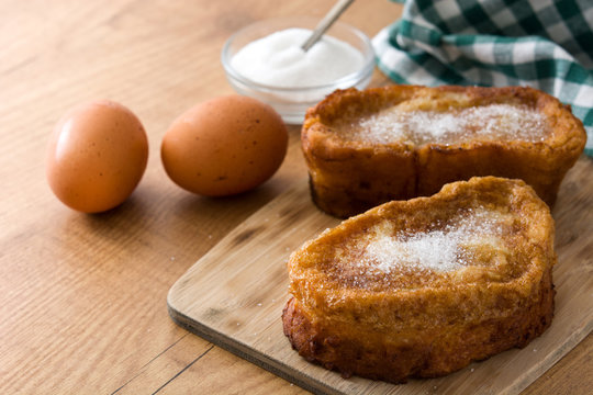 Traditional homemade Spanish torrijas on wooden background. Easter dessert.