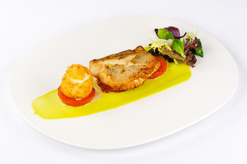 fried fish sauce tomatoes appetizer greens on a plate