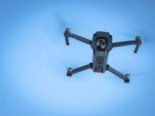 Drone flying in the blue sky, unmanned copter flight,