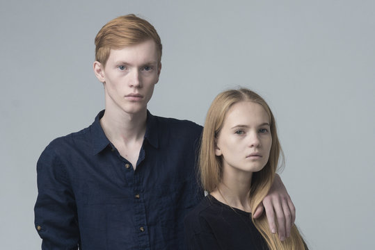 Portrait of serious Caucasian couple hugging