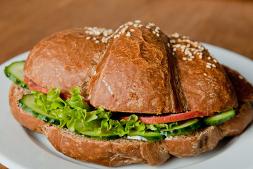 Rye croissant with salami and fresh cucumber