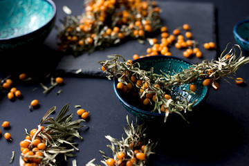 A branch of sea-buckthorn in a plate