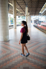 Young girl at a city train station. 