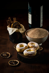 Few homemade cream puffs on vintage dark board with cinnamon sugar