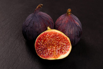 Fresh figs on a black background. Figs cut in half, in section